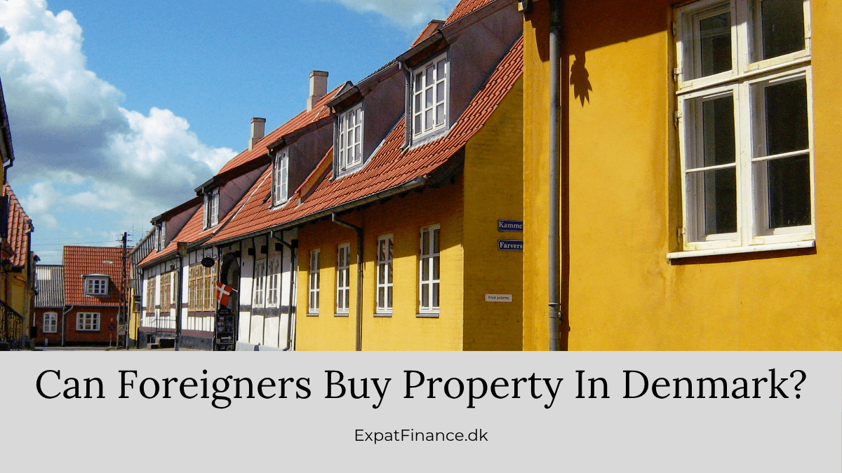 Row of traditional yellow and timber-framed Danish houses under a blue sky, with text asking if foreigners can buy property in Denmark.