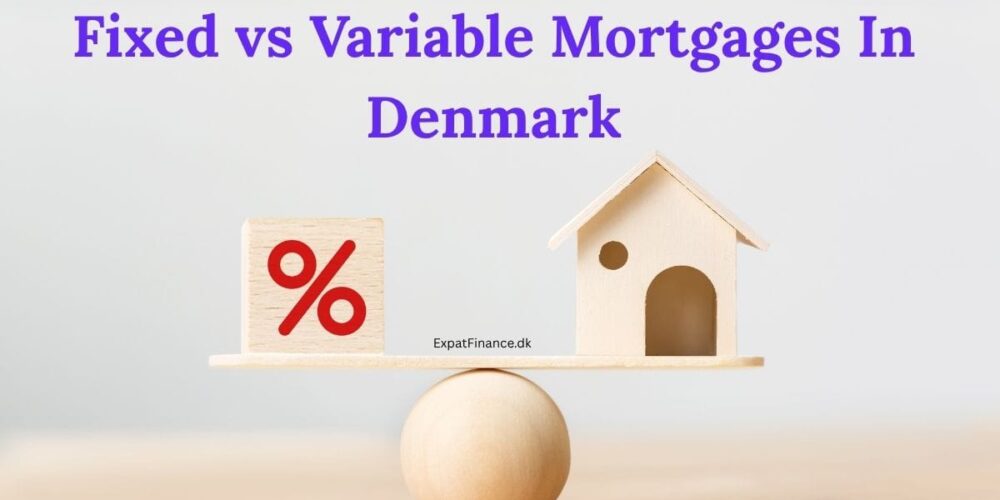 A wooden balance scale on a light background. On the left side of the scale is a wooden block with a red percent symbol (%), and on the right side is a small wooden house figurine. Bold text at the top of the image reads, 'Fixed vs Variable Mortgages In Denmark,' and the text 'ExpatFinance.dk' is visible near the center