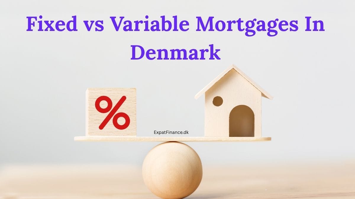A wooden balance scale on a light background. On the left side of the scale is a wooden block with a red percent symbol (%), and on the right side is a small wooden house figurine. Bold text at the top of the image reads, 'Fixed vs Variable Mortgages In Denmark,' and the text 'ExpatFinance.dk' is visible near the center