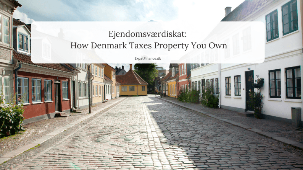 Cobblestone street lined with colorful Danish houses featuring text overlay: Ejendomsværdiskat: How Denmark Taxes Property You Own