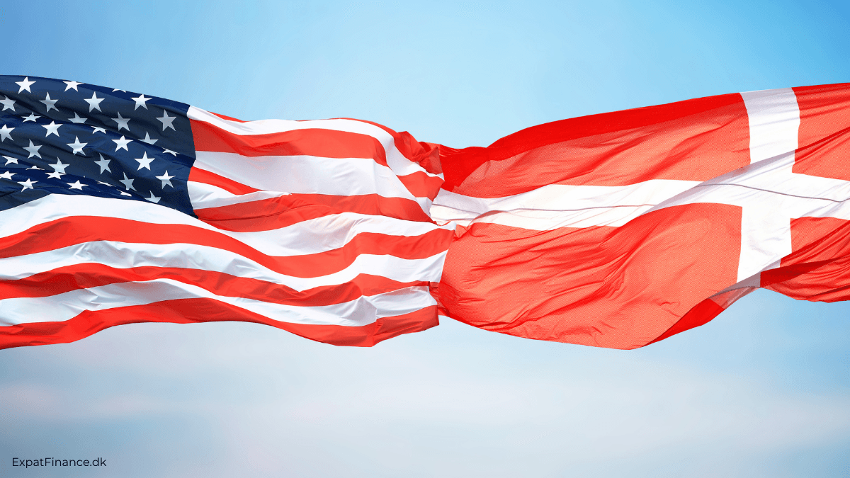 American and Danish flags waving together against a blue sky, symbolizing US–Denmark relations, international business, and expat life